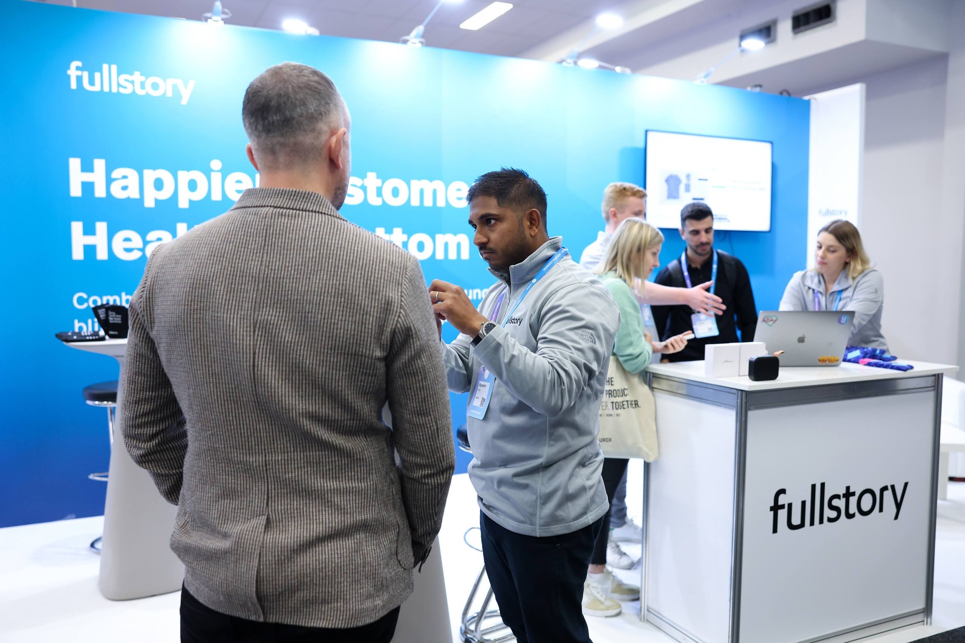 UXDX partner conversations at an exhibition stand