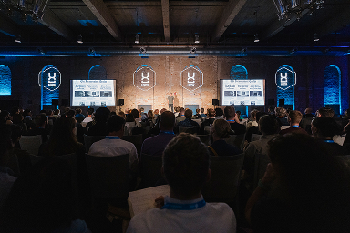 Audience watching a talk in the main UXDX hall