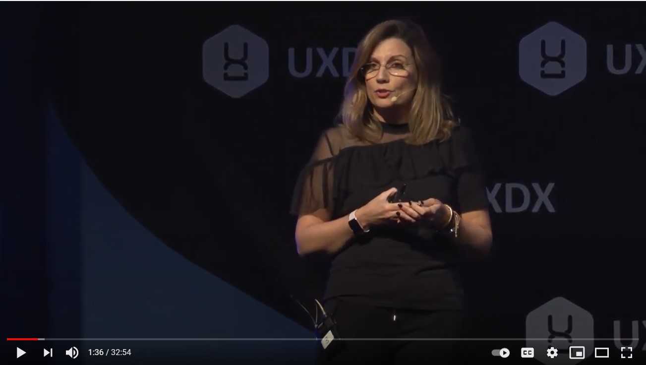 Speaker on stage at UXDX