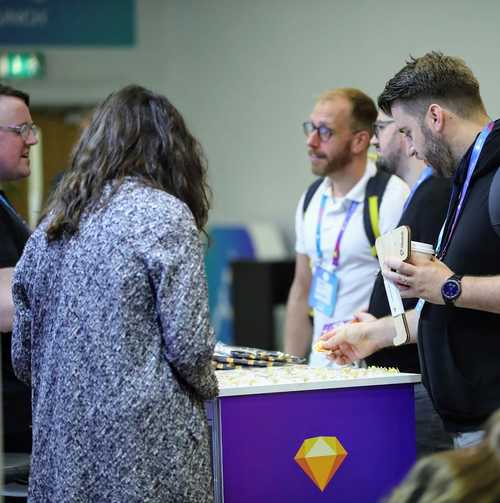 People talking at an exhibition stand